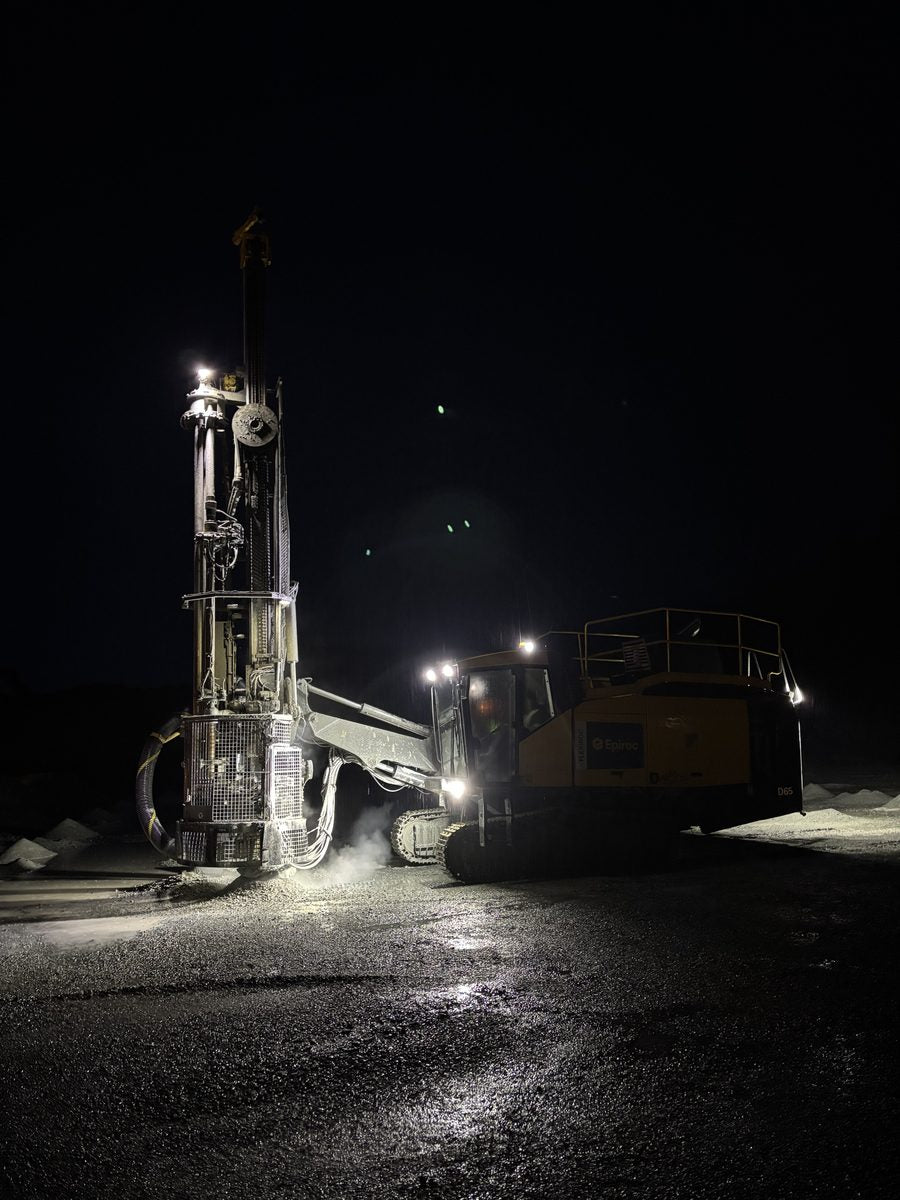 Blasting World Instagram post: a drill rig lit up working at night
