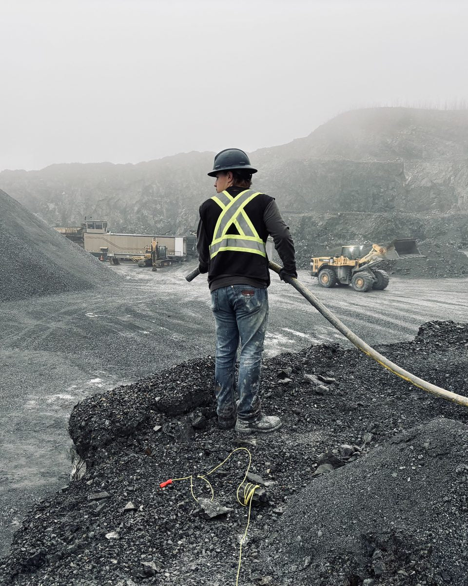 Blasting World Instagram post: a blaster loading a shot overlooking the quarry
