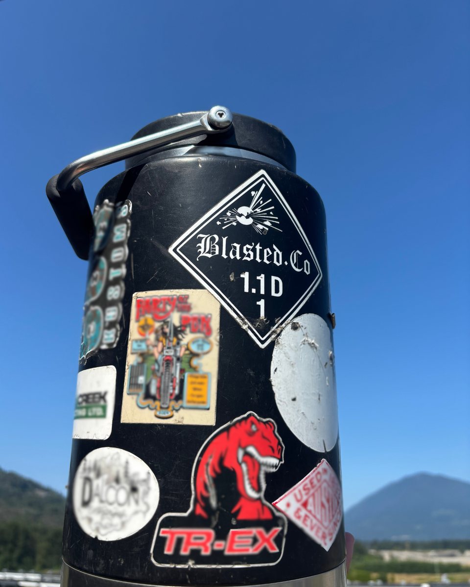 Water bottle covered in Blasted.Co stickers