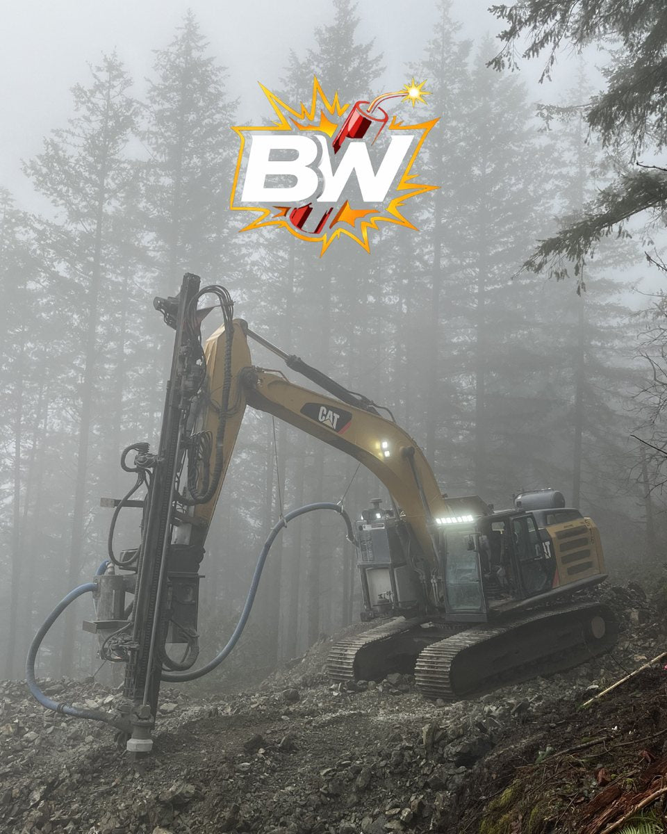 Drill rig on a rock face in the fog