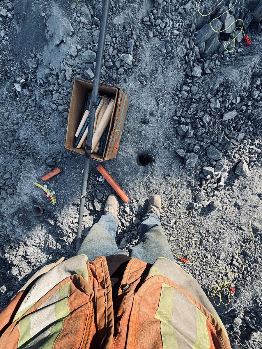 Blasting World Instagram post: loading a blast pattern with explosive cartridges and det cord