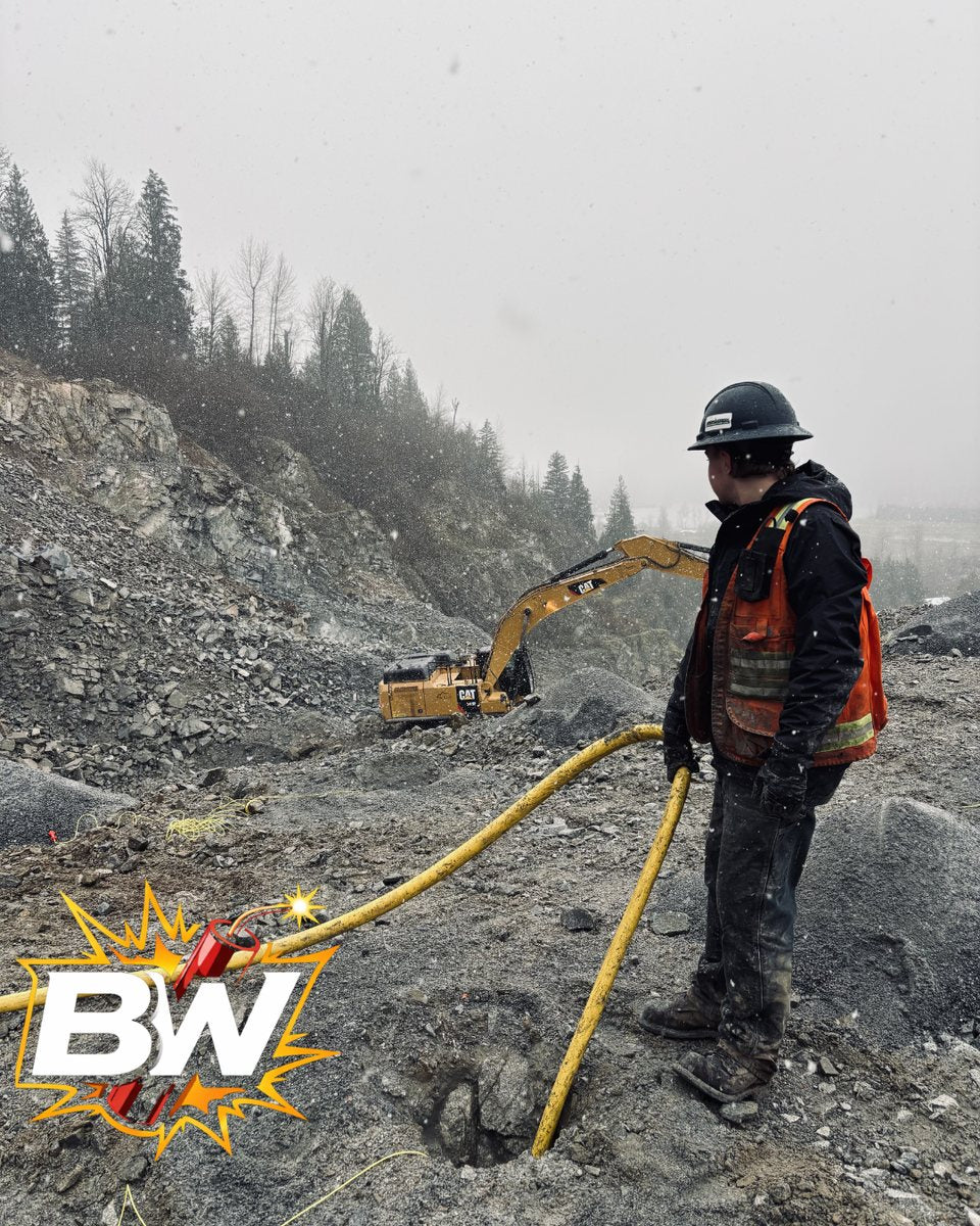 Blaster on a jobsite loading a shot in the snow